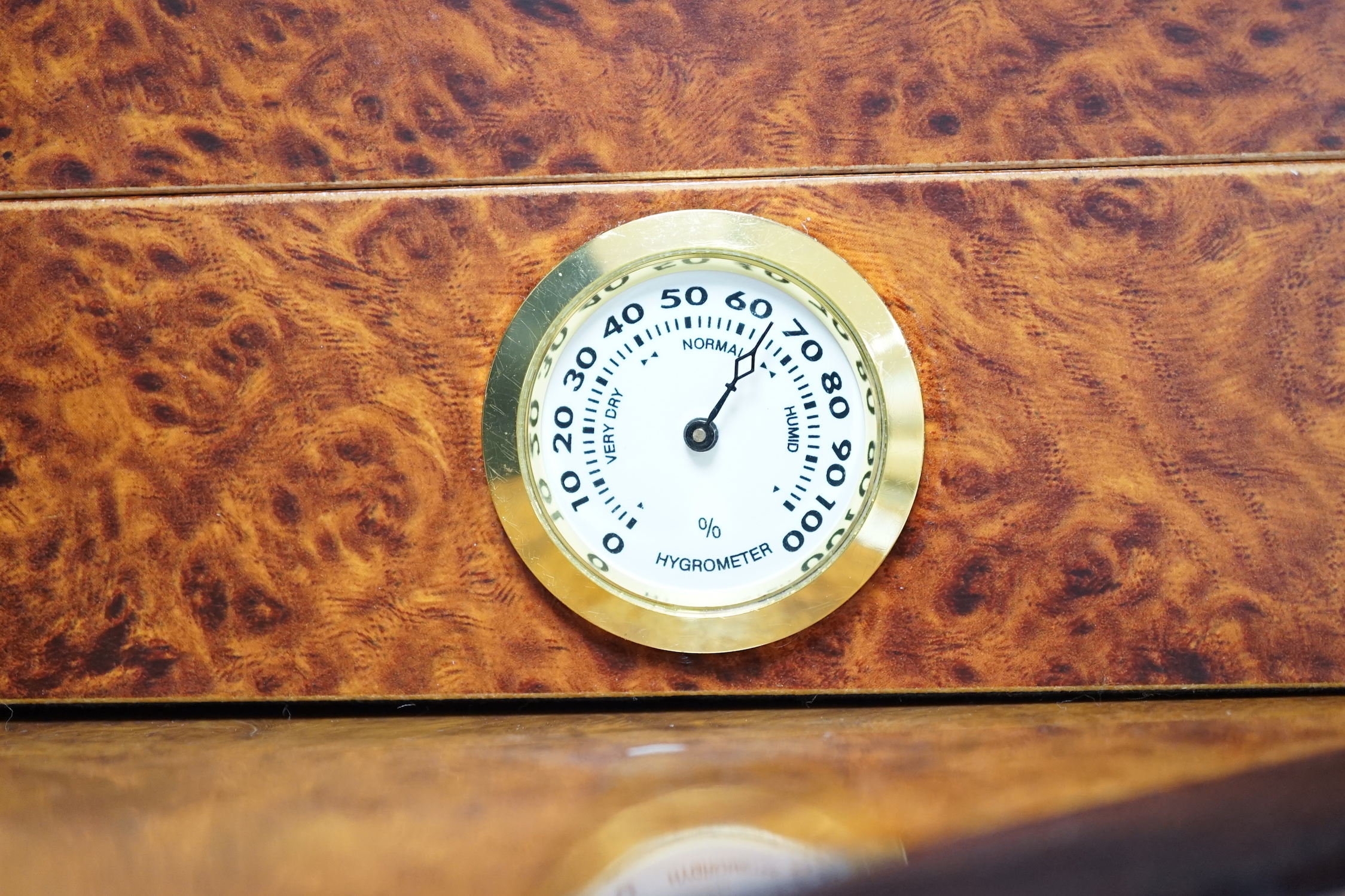 Two burr wood humidors, one with contents including Cohiba